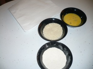 Bowls of whipped eggs, panko breadcrumbs with garlic powder, and flour